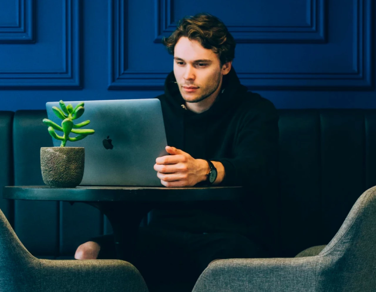 sitting man with laptop